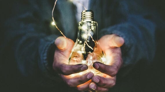 Man holding lightbulb Canadians have a duty to truly understand energy issues