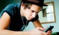 Young man on a cell phone Equipping young people to better manage their financial futures