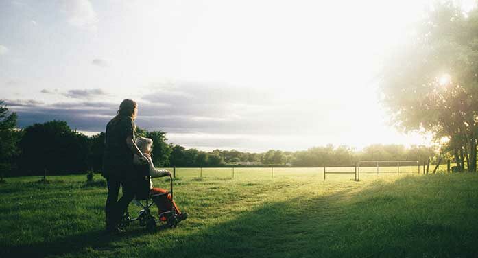 wheelchair caregiver sunset nature sunrise service Roots of happiness are found in service to others
